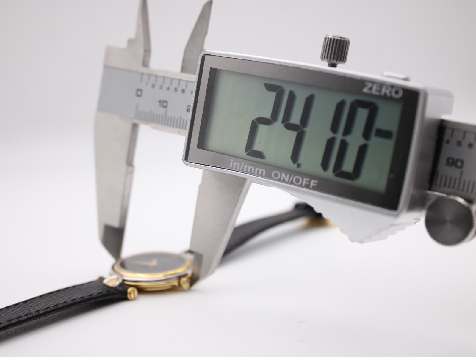 Digital caliper measuring the case diameter of the Gucci 4500L, displaying a precise reading of 24.10mm.