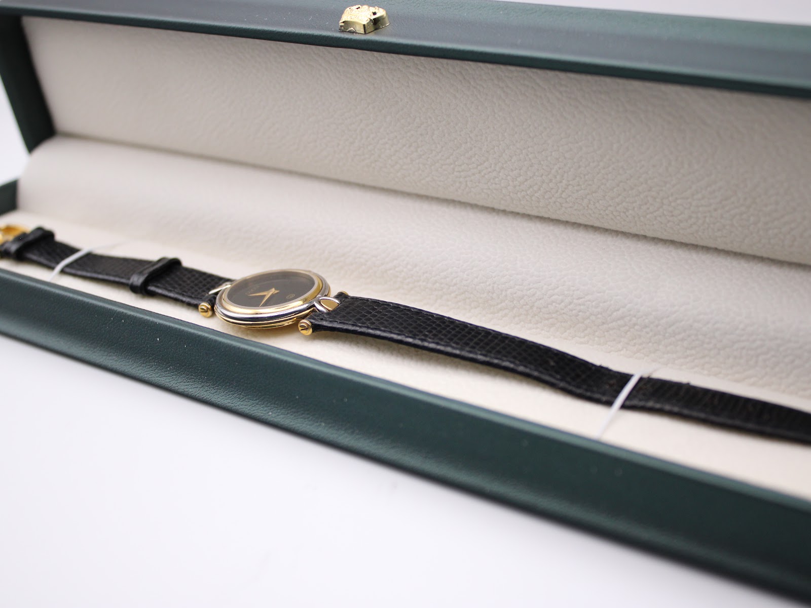 The Gucci 4500L watch resting within a green presentation box, highlighting its elegant appearance.