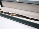 The Gucci 4500L watch resting within a green presentation box, highlighting its elegant appearance.