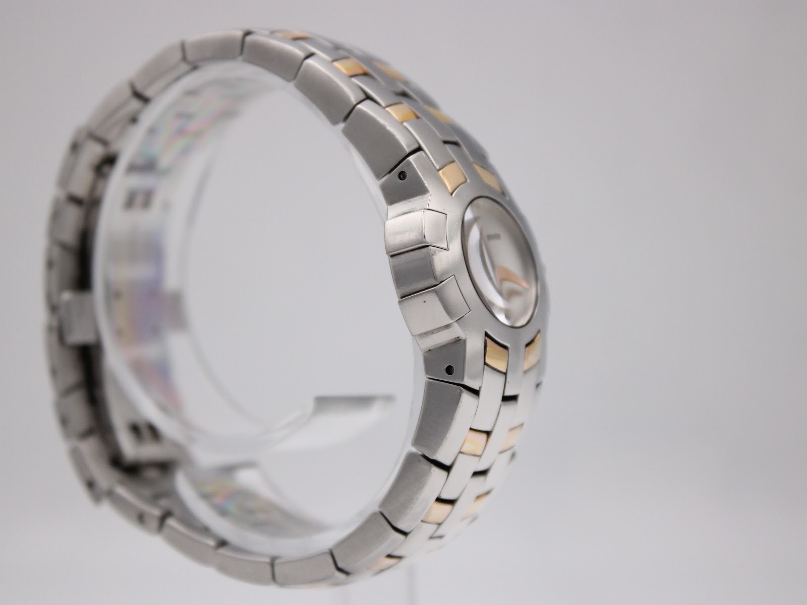 Angled side view of the Maurice Lacroix watch highlighting the two-tone gold-tone and silver steel bracelet.