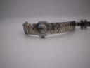 Full length view of the Maurice Lacroix watch, laid flat, showcasing the entire two-tone bracelet.