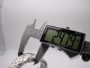Digital caliper measuring the case diameter of the watch, displaying 24.79mm.