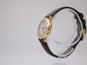 Side view of the Gucci 3800L watch on a display stand, showing the signed crown and the profile of the gold-plated case.