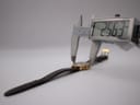 Digital caliper measuring the watch case diameter at precisely 25.63 mm, with the watch and strap extended.