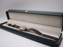 The Gucci 3800L watch resting within an open green presentation box on a white background.