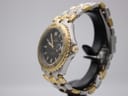 Right side view of the Ellesse watch on a stand, highlighting the gold-tone crown and bezel edge.