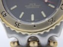 Macro close-up of the black dial showing 'swiss movt' text, luminous hour markers, and '200 M water resistant performance' text.