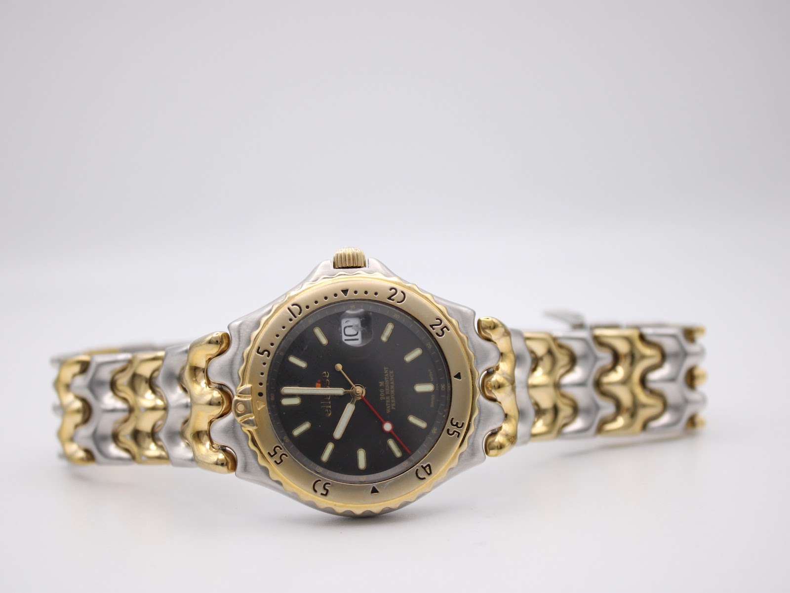 Full front view of the Ellesse watch with its two-tone bracelet laid flat against a white background.