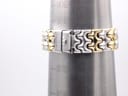 The two-tone bracelet on a wrist sizing gauge, indicating a fit of approximately 170-175mm.