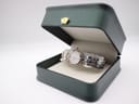 Front view of Maurice Lacroix bi-colour watch presented in its dark green original box.