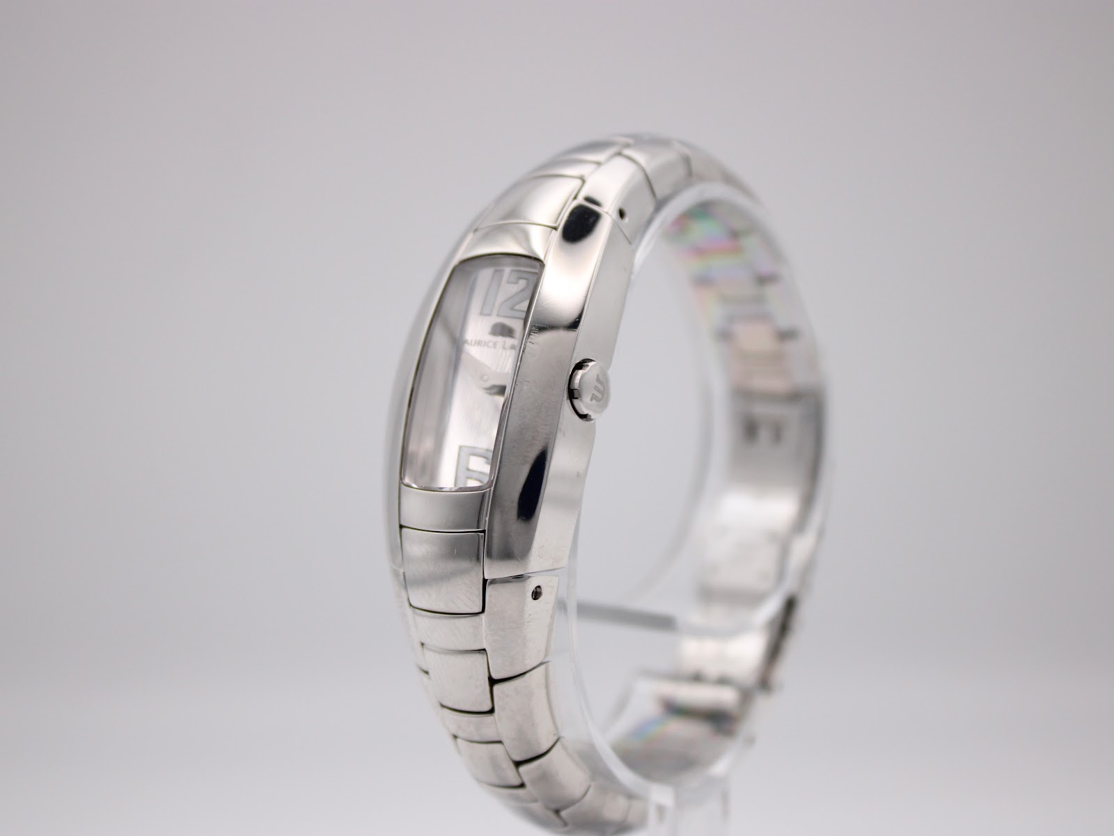 Right side view of the Maurice Lacroix watch, highlighting the curved stainless steel case and push/pull crown detail.