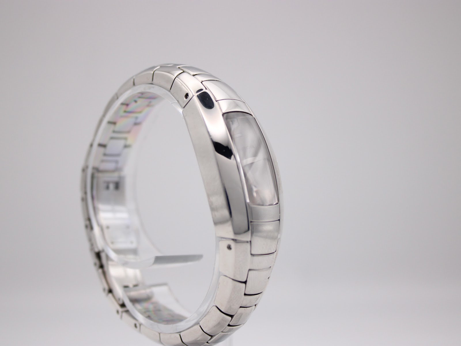 Left side view of the Maurice Lacroix watch, showcasing the elegant curve of the stainless steel case and integrated bracelet design.