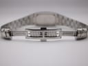 Rear view of the open stainless steel butterfly clasp, showing the inner mechanism of the bracelet.