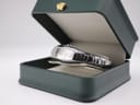 Maurice Lacroix watch resting inside a dark green presentation box with a cream interior, displaying the watch's front.