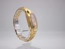 Opposite side view of the Maurice Lacroix watch on a stand, showcasing the continuous flow of the gold-plated bracelet.