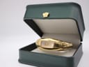 The Maurice Lacroix gold-plated watch displayed open in a dark green presentation box with a golden crown emblem.