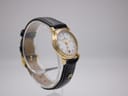 Opposite angled side view of the Maurice Lacroix 72963 watch on a stand, highlighting the classic round case shape.