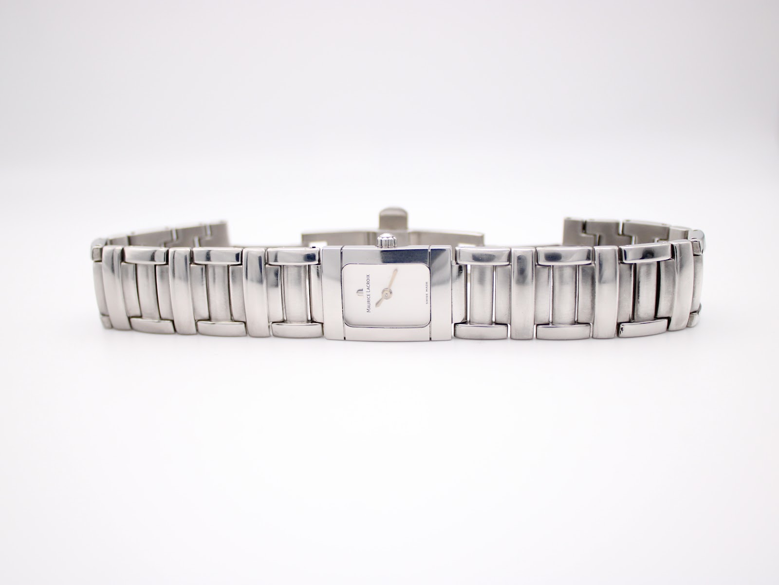 Full length view of the Maurice Lacroix stainless steel bracelet watch lying flat, showing the folded clasp