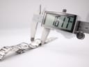 Close-up of a digital caliper measuring the watch case, displaying a width of 16.17 mm