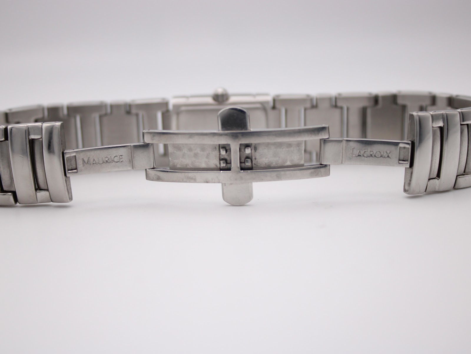 Close-up of the stainless steel deployant clasp, clearly showing 'Maurice' and 'Lacroix' engraved on either side