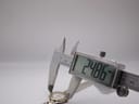 Digital caliper measuring the watch case diameter, displaying 24.86 mm. The watch dial and two-tone bracelet are partially visible.