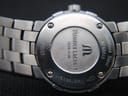 Close-up of the polished stainless steel case back, showing brand, model, serial numbers, sapphire crystal, and 100m water resistance.