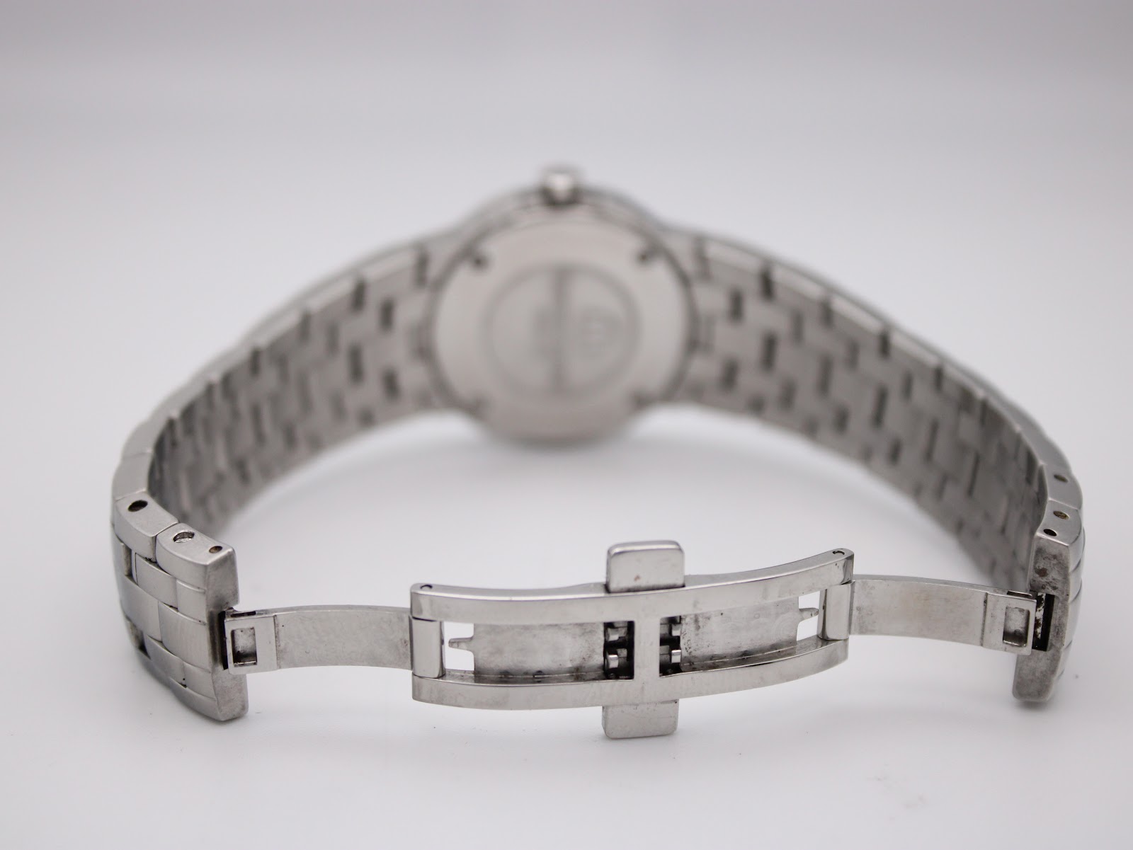 Rear view of the watch with the deployment clasp open, showing the internal mechanism of the bracelet.