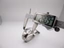 Digital caliper measuring the watch case, showing an exact diameter of 28.09 mm.