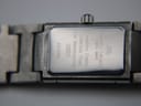 Close-up of the polished stainless steel case back, showing Maurice Lacroix, Swiss Made, sapphire crystal, stainless steel, 50m water resistant, model 32823, and serial AB10566 engravings.
