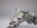 Digital caliper measuring the case width of the watch, displaying 16.11mm.