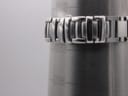 Close-up of the stainless steel bracelet on a wrist sizing gauge, indicating a wrist size of approximately 18.3cm.