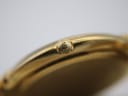 Macro shot of the signed Maurice Lacroix crown on the gold electroplated watch case.