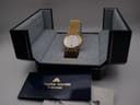 Maurice Lacroix watch displayed in its original presentation box, with a booklet visible in the foreground.