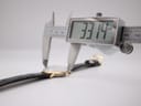 Digital caliper showing the precise case diameter measurement of 33.14mm across the watch case.