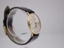 Opposite side profile view of the Rotary watch on a display stand, showing the curvature of the case.