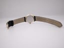 Back view of the Rotary watch and strap laid flat, showing the 'Rotary' embossing on the strap interior and case back.
