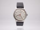 Front view of Garrard watch with silver dial, applied Arabic numerals, red central seconds hand, and grey leather strap.