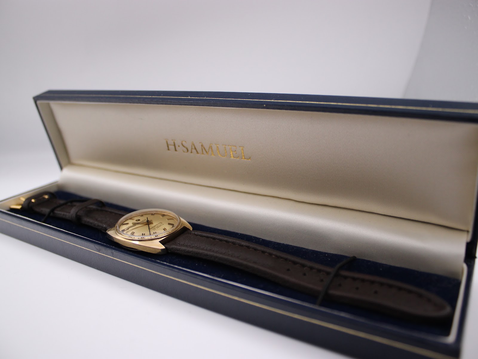 Roamer Superking watch resting inside a blue H. Samuel presentation box with gold lettering.