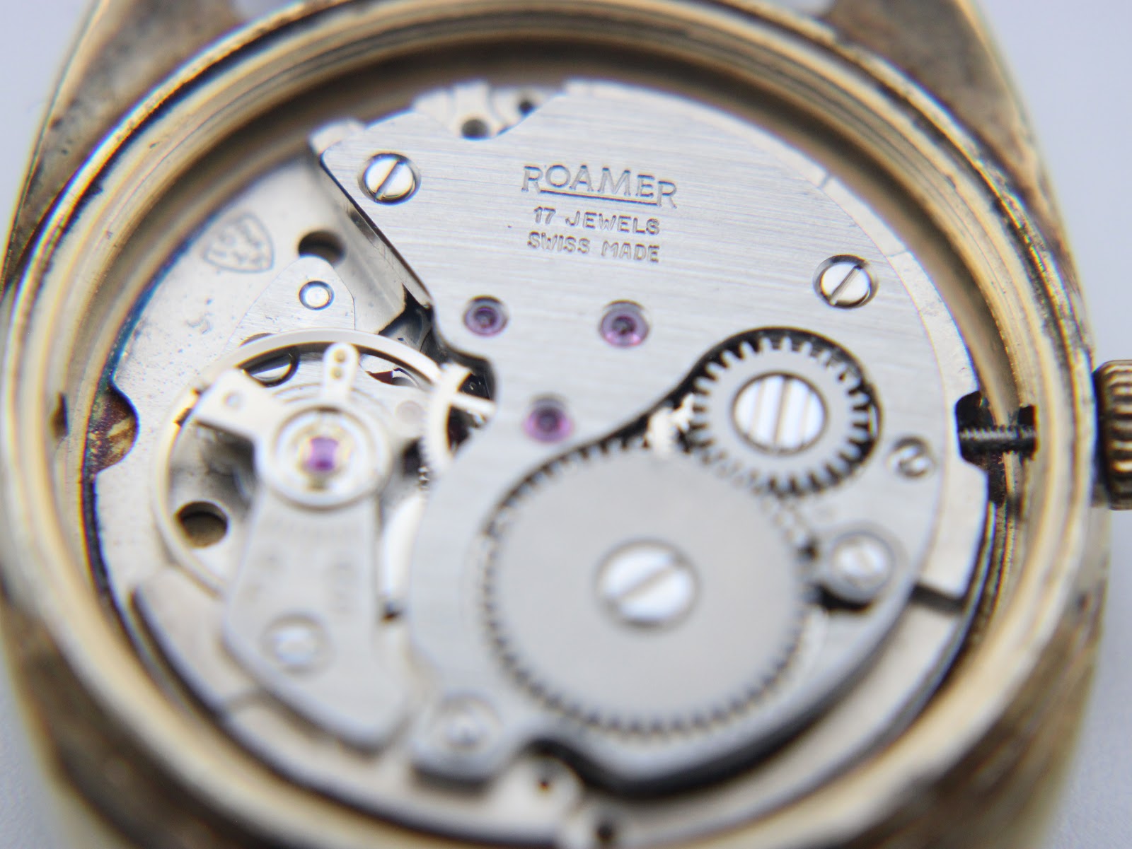 Macro shot of the Roamer manual wind movement, showing 17 jewels and 'Swiss Made' engraving.