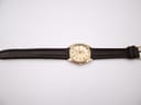 Top-down full view of the Roamer Superking watch with its dark brown leather strap laid flat on a white background.