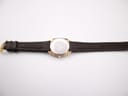 Full view of the Roamer Superking watch from the back, showing the case back and the dark brown leather strap laid flat.