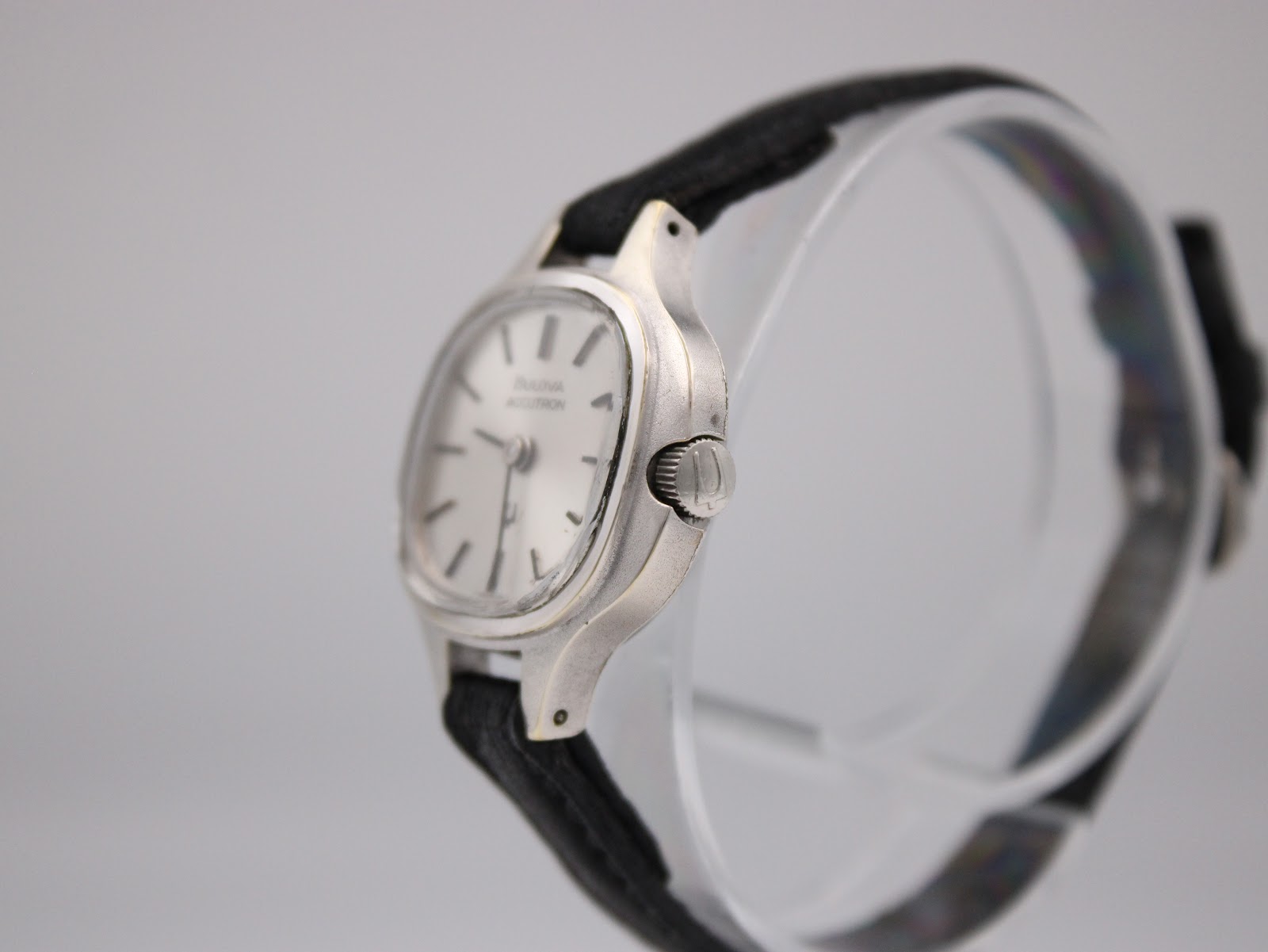 Angled side view of the Bulova Accutron watch case and crown, showing the silver-toned finish and strap.