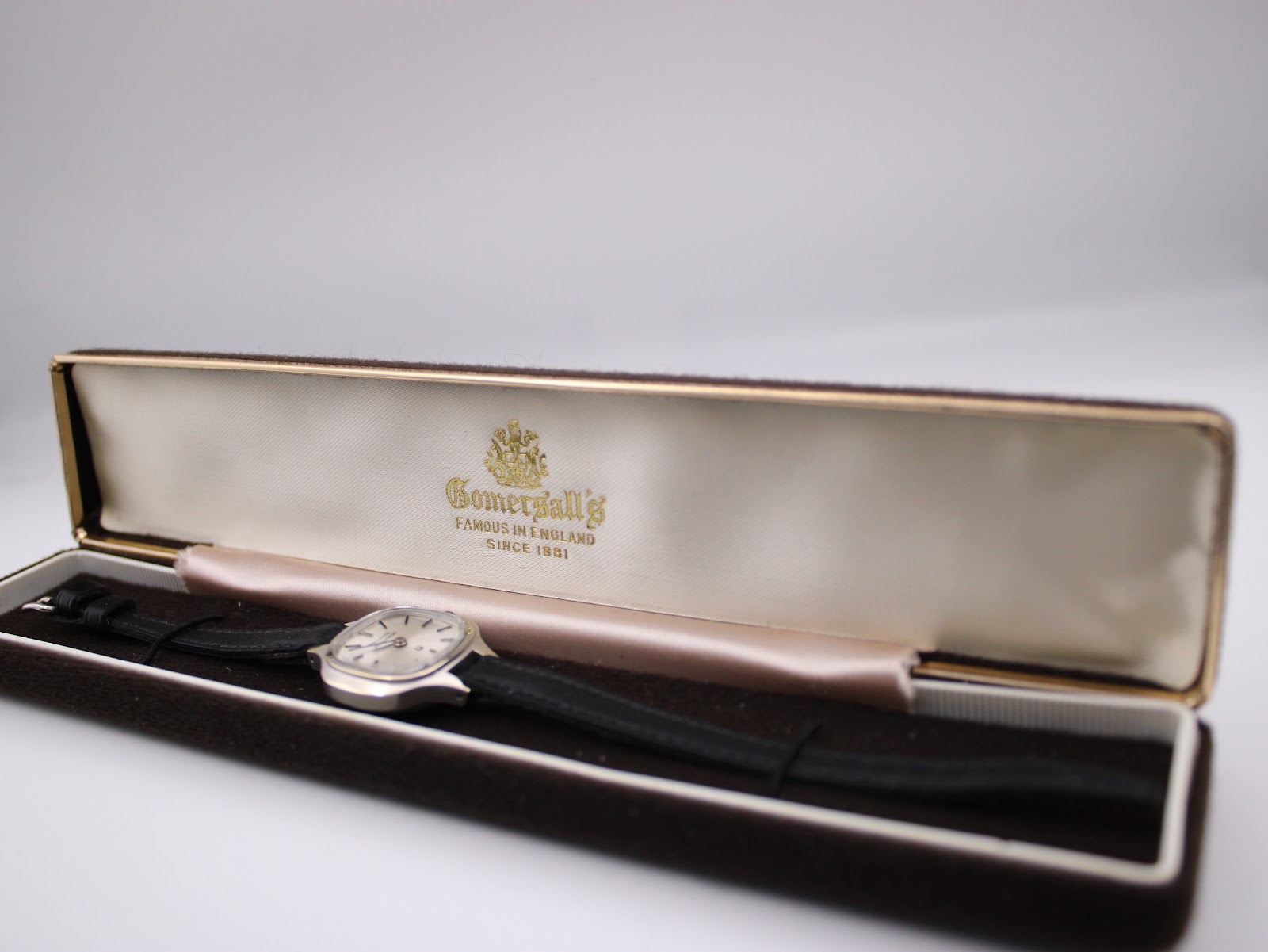 Bulova Accutron watch displayed inside a non-original brown velvet presentation box.