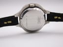 Rear view of the Bulova Accutron watch case back, showing "BEZEL GOLD PLATED G 20 MICRONS STAINLESS STEEL BACK" engraving and serial number.