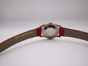 Rear view of the Rone watch showing the stainless steel case back and the red leather strap, with "GENUINE SNAKESKIN/LEATHER" visible on the inside of the strap.