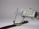 Digital caliper measuring the case diameter of the watch, displaying a precise reading of 31.11mm.