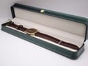 The Raymond Weil Genève watch presented neatly within a green jewellery box, highlighting its elegant display.