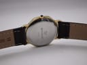 Rear view of the watch, showing the stainless steel case back with "RAYMOND WEIL 7030" engraving and the dark brown leather strap with 18mm lug width marking.