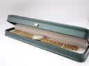 The Raymond Weil gold plated watch presented inside its original dark green presentation box with a cream interior.