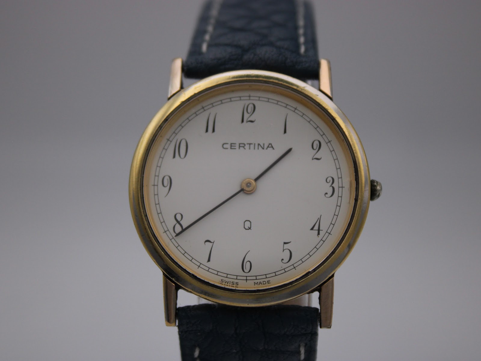 Close-up front view of the Certina white dial with black Arabic numerals and 'Certina Swiss Made' text.